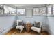 Cozy sitting area with natural light, neutral furniture, rug, and hardwood floors at 3833 Umatilla St, Denver, CO 80211