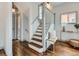 Bright entry featuring hardwood floors, staircase, and hall bench at 3833 Umatilla St, Denver, CO 80211