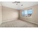 Bright bedroom with neutral carpet and large window showcasing the neighborhood at 8571 Gold Peak Dr # C, Highlands Ranch, CO 80130