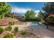 Outdoor pool area with lounge chairs, mature trees, and a retaining wall showcasing landscape design at 8571 Gold Peak Dr # C, Highlands Ranch, CO 80130