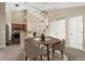 Bright dining area featuring a round table, stylish lighting, and an open layout to the kitchen and living spaces at 8571 Gold Peak Dr # C, Highlands Ranch, CO 80130