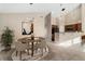 Open-concept dining area with modern chandelier and views into the kitchen at 8571 Gold Peak Dr # C, Highlands Ranch, CO 80130