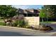 Community entrance with a decorative sign, rock feature, and colorful landscaping, creating a welcoming first impression at 8571 Gold Peak Dr # C, Highlands Ranch, CO 80130