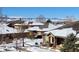 Charming neighborhood homes covered in snow, with mountain views in the background, under a clear blue sky at 8571 Gold Peak Dr # C, Highlands Ranch, CO 80130