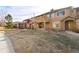 Exterior view of townhomes showcasing stone accents, covered balconies, and well-kept lawns at 8571 Gold Peak Dr # C, Highlands Ranch, CO 80130