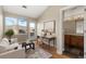 Cozy living room with vaulted ceiling, a modern desk, and views of the outdoors at 8571 Gold Peak Dr # C, Highlands Ranch, CO 80130