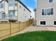 Fenced backyard with lawn and patio connecting the two houses at 16893 Trail View Cir, Parker, CO 80134
