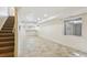 Finished basement with tiled floor, recessed lighting, and stairs to the main level at 16893 Trail View Cir, Parker, CO 80134