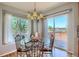 Dining area with bright windows and sliding door access to the deck with views of the outdoors at 16893 Trail View Cir, Parker, CO 80134