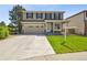 Front exterior of two-story home with a two car garage, manicured lawn, and inviting front porch at 16893 Trail View Cir, Parker, CO 80134