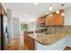 Kitchen boasts granite counters, stainless steel appliances, wood cabinetry, and natural light at 16893 Trail View Cir, Parker, CO 80134