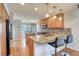 Open kitchen with granite countertops, an island with seating, stainless steel appliances and wood floors at 16893 Trail View Cir, Parker, CO 80134