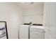 Laundry room featuring white washer and dryer, wire shelving, and a white door at 16893 Trail View Cir, Parker, CO 80134