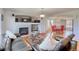Open-concept living room with hardwood floors, fireplace, and seamless flow to dining area at 16893 Trail View Cir, Parker, CO 80134