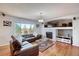 Comfortable living room featuring a fireplace, large windows, and ample space for relaxing at 16893 Trail View Cir, Parker, CO 80134