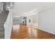 Bright living room features gleaming hardwood floors, lots of natural light, and an open staircase at 16893 Trail View Cir, Parker, CO 80134
