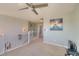 Loft area featuring neutral walls, carpet, a ceiling fan, and windows with lots of natural light at 16893 Trail View Cir, Parker, CO 80134