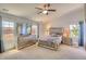 Main bedroom featuring a ceiling fan, carpet, a walk-in closet, and several sunny windows at 16893 Trail View Cir, Parker, CO 80134