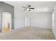 Spacious main bedroom with carpeted floors, ceiling fan, and doorways to the bathroom and hallway at 16893 Trail View Cir, Parker, CO 80134