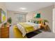 Cozy bedroom with mid-century modern furniture and yellow accents at 8787 Yukon St, Arvada, CO 80005