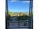 A beautiful mountain view from a private balcony through opened french doors with black railings at 410 Acoma St # 518, Denver, CO 80204