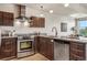 A modern kitchen featuring stainless steel appliances, granite countertops, and wood cabinets at 410 Acoma St # 518, Denver, CO 80204