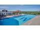 Rooftop pool area featuring a sparkling pool, dining space, and panoramic city views at 410 Acoma St # 518, Denver, CO 80204