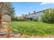 Sprawling backyard with lush green grass, shed, and mature trees at 15909 E Ford Pl, Aurora, CO 80017