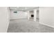 Finished basement space with gray carpet, white pillars, and a fireplace at 15909 E Ford Pl, Aurora, CO 80017