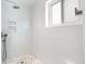 A frameless glass shower with tiled walls and floor create a clean and modern bathroom space at 15909 E Ford Pl, Aurora, CO 80017