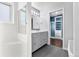 Elegant bathroom features a gray vanity, modern fixtures, and a tiled shower with glass door at 15909 E Ford Pl, Aurora, CO 80017