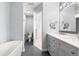 Modern bathroom features a soaking tub, separate shower, and a double vanity with sleek hardware at 15909 E Ford Pl, Aurora, CO 80017