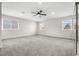 Large bedroom with a ceiling fan and three windows providing natural light, plus mirrored closet doors at 15909 E Ford Pl, Aurora, CO 80017