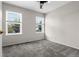 Cozy bedroom with plush carpeting, neutral walls, and two windows offering pleasant outdoor views at 15909 E Ford Pl, Aurora, CO 80017