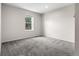 Cozy bedroom with gray carpet, a window offering natural light, and neutral paint color at 15909 E Ford Pl, Aurora, CO 80017