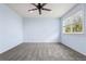 Bedroom features blue walls, carpet, ceiling fan, and a window with natural light at 15909 E Ford Pl, Aurora, CO 80017