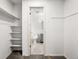 Spacious walk-in closet leading to a bathroom, with ample shelving for organized storage at 15909 E Ford Pl, Aurora, CO 80017