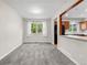 Bright dining room with new gray carpet and a view of the kitchen at 15909 E Ford Pl, Aurora, CO 80017
