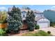Two-story home with light blue paint, a two-car garage, and a charming front porch at 15909 E Ford Pl, Aurora, CO 80017