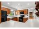 Kitchen with oak cabinets, stainless steel appliances, gas range, and light counter tops at 15909 E Ford Pl, Aurora, CO 80017