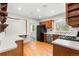 Kitchen with oak cabinets, stainless steel appliances, gas range, and hardwood floors at 15909 E Ford Pl, Aurora, CO 80017