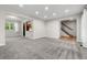 Bright living room with new gray carpet and a view of the staircase and kitchen at 15909 E Ford Pl, Aurora, CO 80017