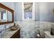 Beautiful bathroom featuring marble-tiled walls, a granite countertop, and a stylish wooden sink at 1351 N Franklin St, Denver, CO 80218