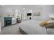 Cozy bedroom features a fireplace, a comfortable armchair, and large windows at 1351 N Franklin St, Denver, CO 80218