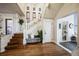 Welcoming foyer with hardwood floors, elegant staircase, and decorative chandelier at 1351 N Franklin St, Denver, CO 80218