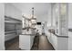 Bright kitchen featuring white cabinetry, stainless steel appliances, and center island with seating at 1351 N Franklin St, Denver, CO 80218