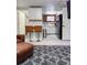 Modern kitchen with bar seating, white cabinets, and stainless-steel appliances, open to the living area at 1351 N Franklin St, Denver, CO 80218