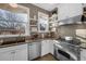 This charming kitchen features stainless steel appliances, floating shelves, and ample counter space at 1351 N Franklin St, Denver, CO 80218