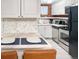 Updated kitchen featuring white cabinets, stainless-steel appliances, and stylish countertops for modern living at 1351 N Franklin St, Denver, CO 80218