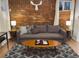 Inviting living room features a brick wall, plush sofa, and stylish decor, creating a cozy atmosphere at 1351 N Franklin St, Denver, CO 80218